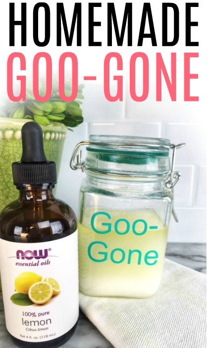 Homemade Goo Gone in a glass jar next to a glass bottle of lemon essential oil.