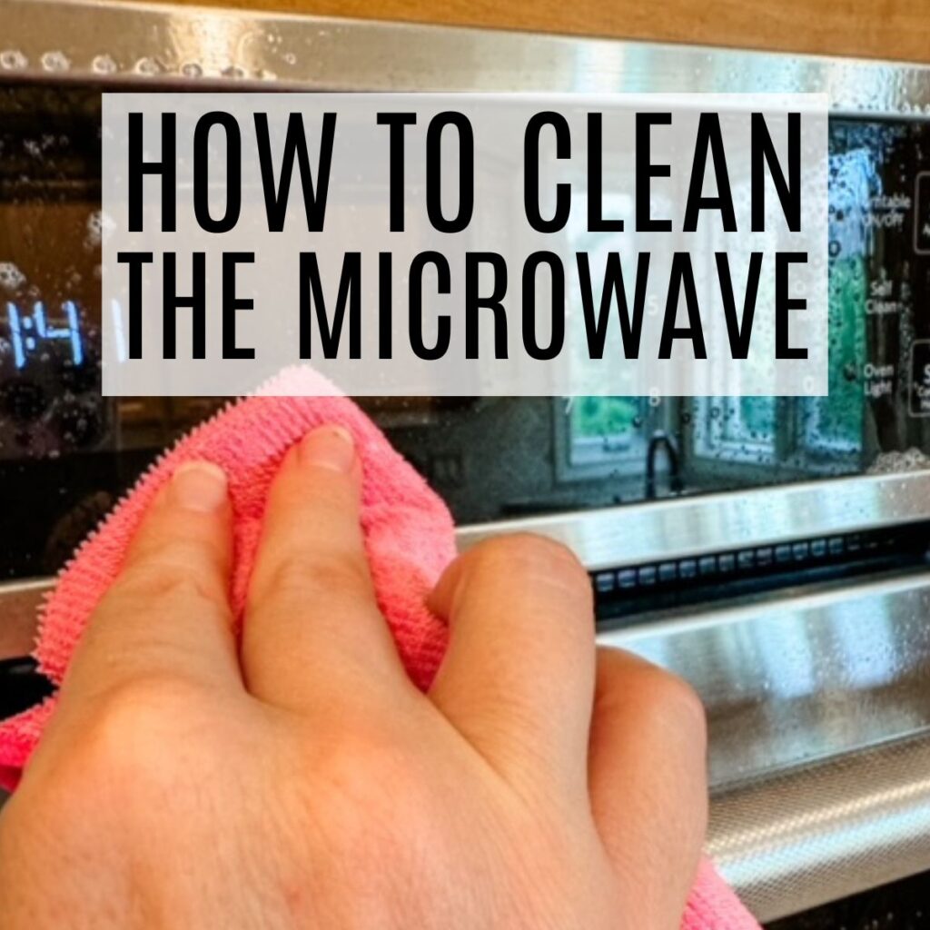 person cleaning microwave