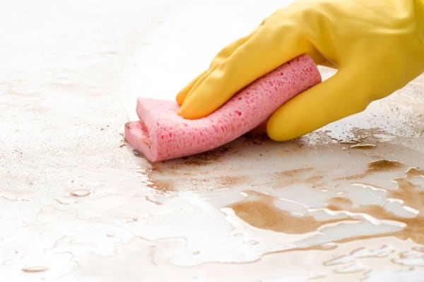 person cleaning stain from counter