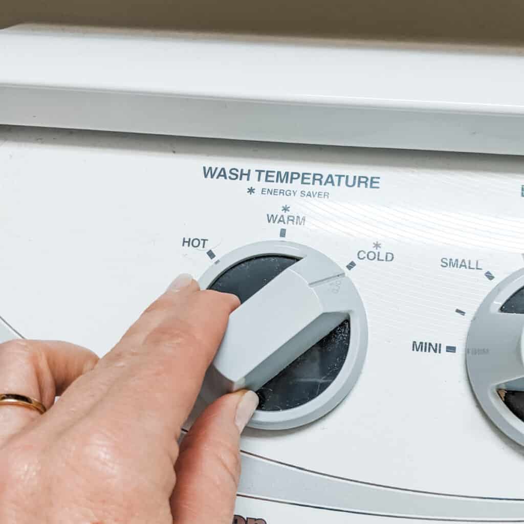 Turning the washing machine to the cold cycle.