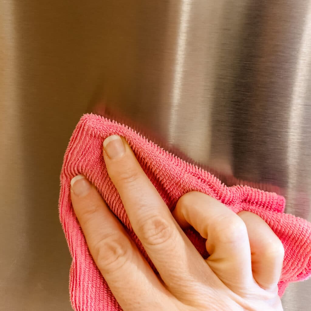 Wiping the appliance with oil to prevent fingerprints and smudging.