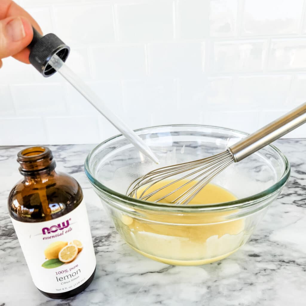 Adding lemon essential oil to goo gone mixture.