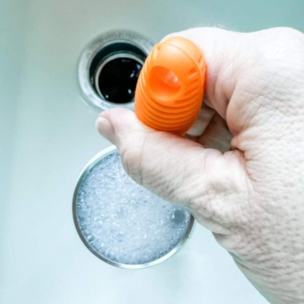 cleaning water bottle with a scrub brush