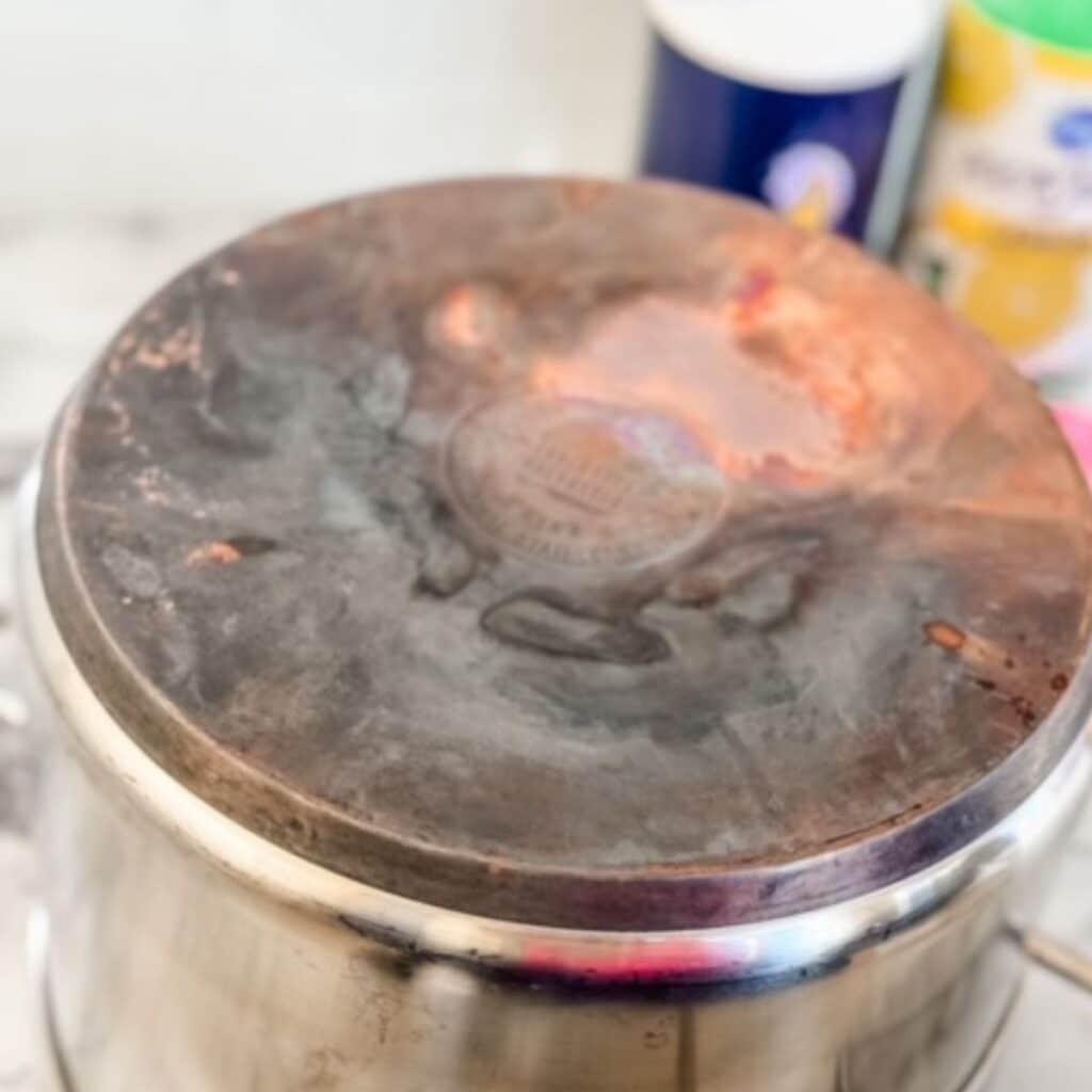 dirty copper pot with lemon juice and salt in the background