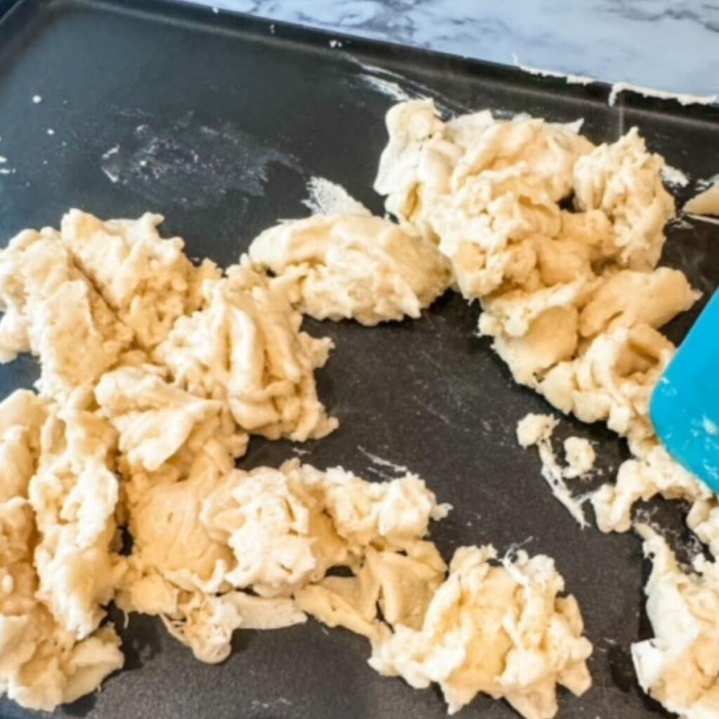 scrambled pancakes on griddle